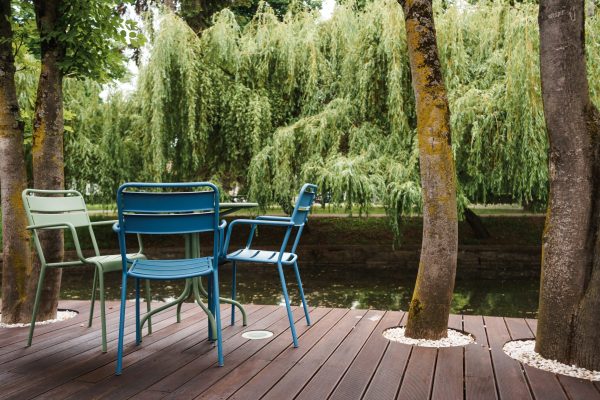 A beautiful shot of empty tables and chairs restaurant's outdoor seating area